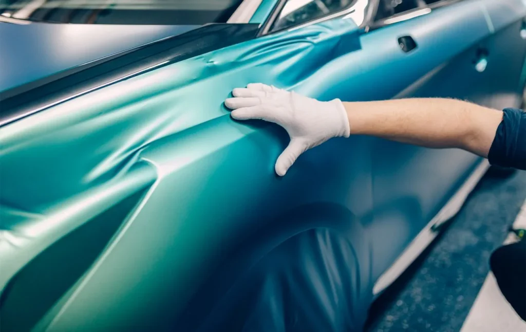 DTG vs DTF printing comparison showing a smooth vinyl-style transfer being applied to a surface for durability and finish