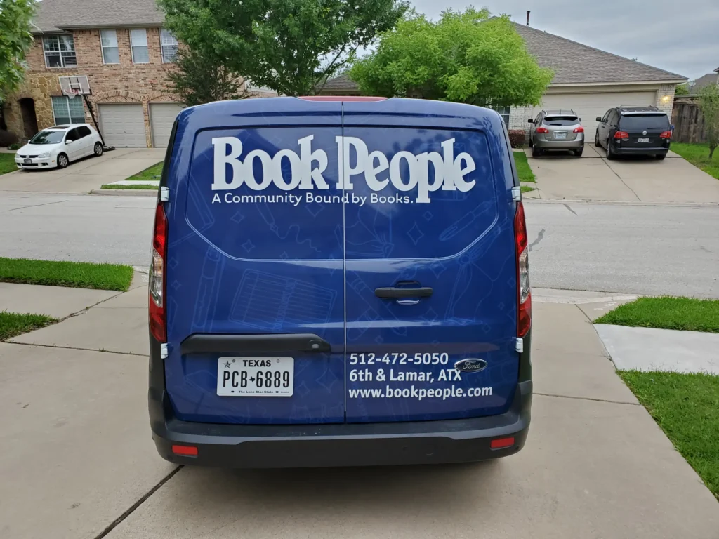 Rear view of custom van wrap showcasing BookPeople branding and professional vehicle wrap installation in Austin Texas