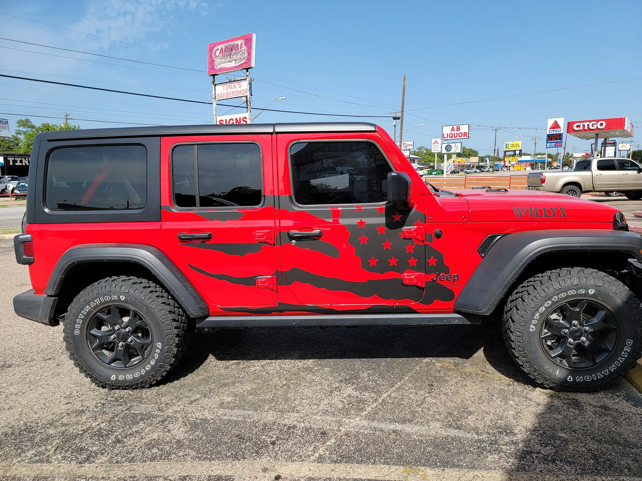 Jeep Wrangler custom vehicle wrap parked outside wrap shop in Austin Texas showing professional vinyl wrap design